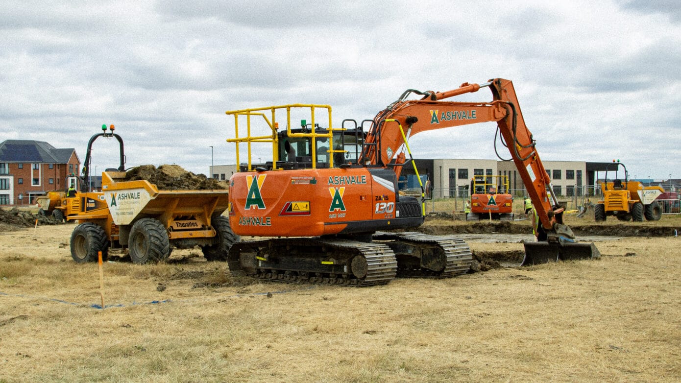 Excavator and dumper working at construction site.