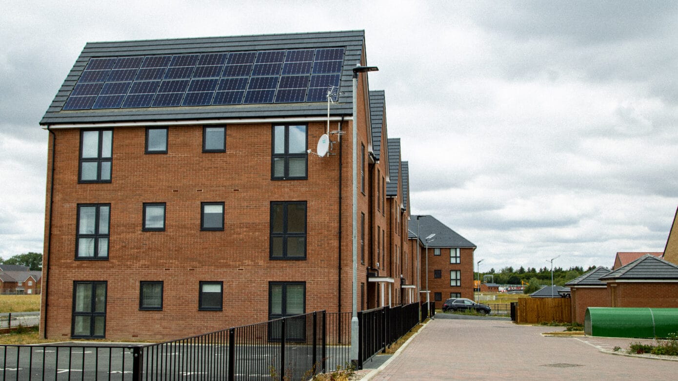 Brick building with solar panels and satellite dish