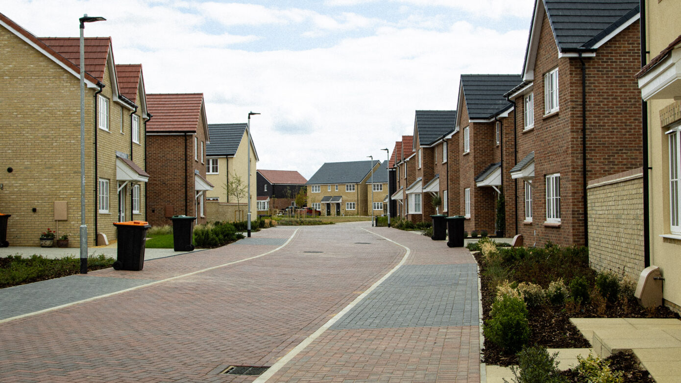 Newly-built suburban houses along quiet street.